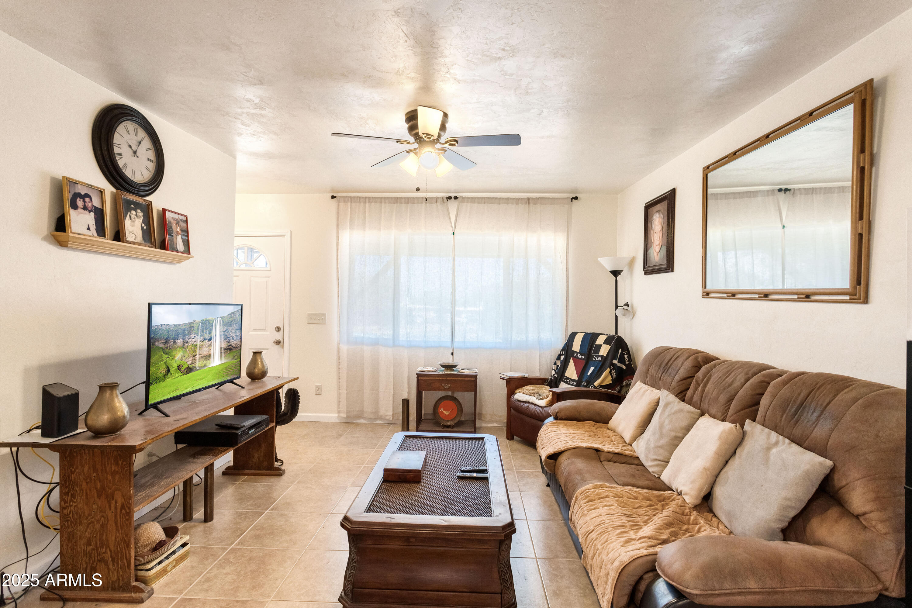 4964 East Raffaele Avenue Sierra Vista, AZ 85635 - Photo 9 of 41 a living room with furniture a rug and a window