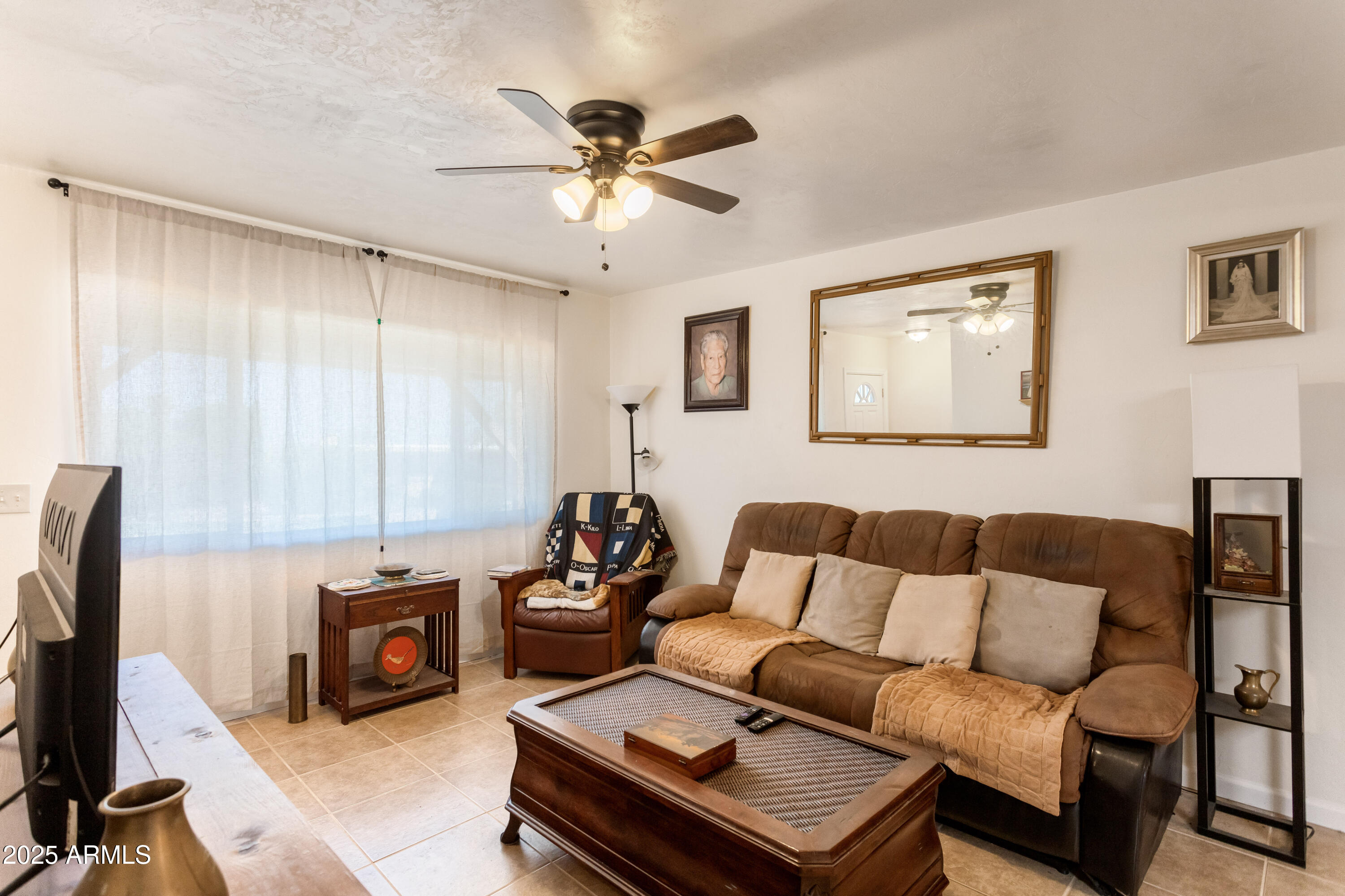 4964 East Raffaele Avenue Sierra Vista, AZ 85635 - Photo 10 of 41 a living room with furniture a flat screen tv and a window