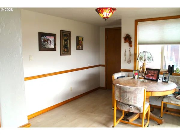 a view of a room with a table and chairs