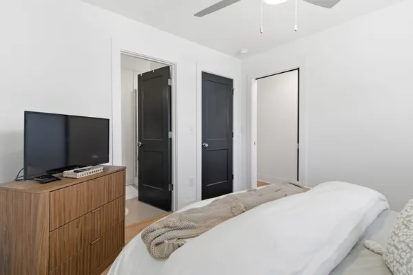 a bedroom with a bed and a flat screen tv