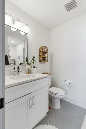 a bathroom with a toilet a sink and mirror