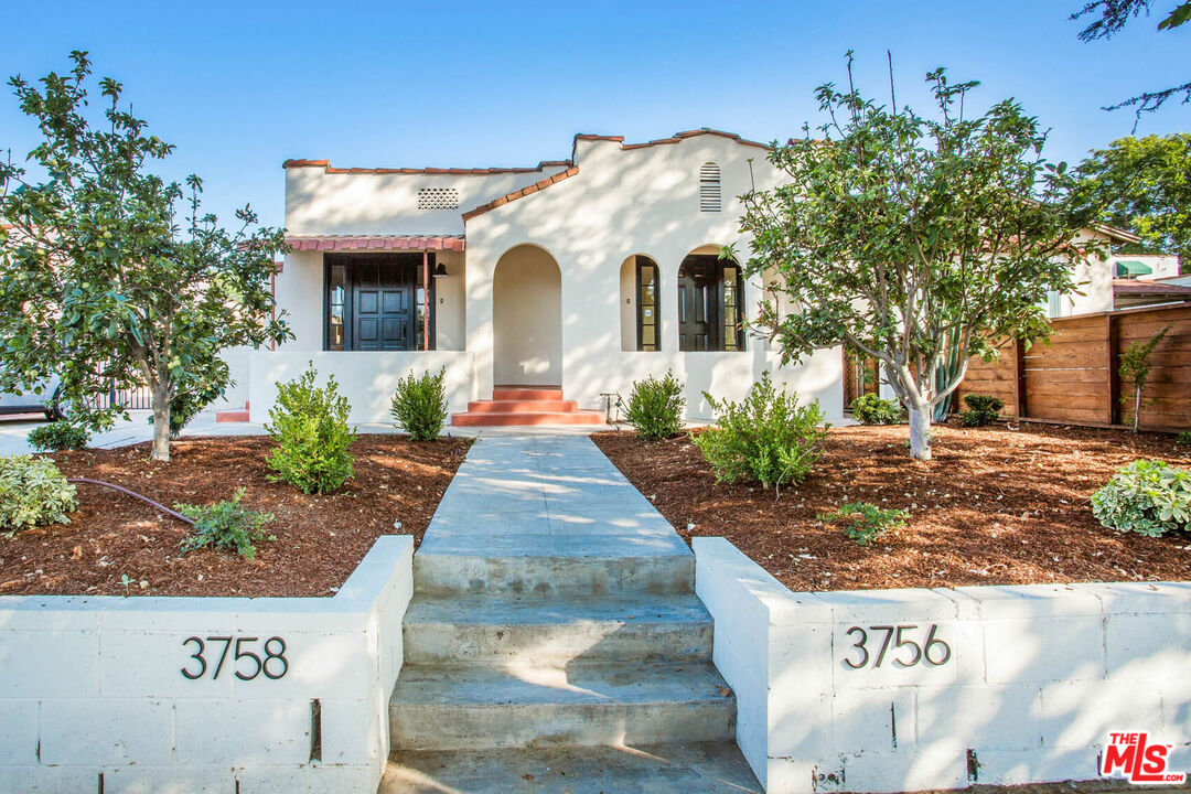 a view of a white house with sign broad
