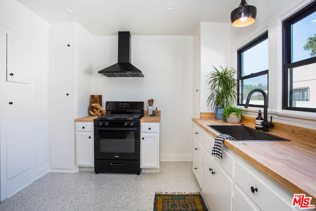 3756 Dover Place Los Angeles, CA 90039 - Photo 8 of 19 a kitchen with stainless steel appliances a stove and a white refrigerator