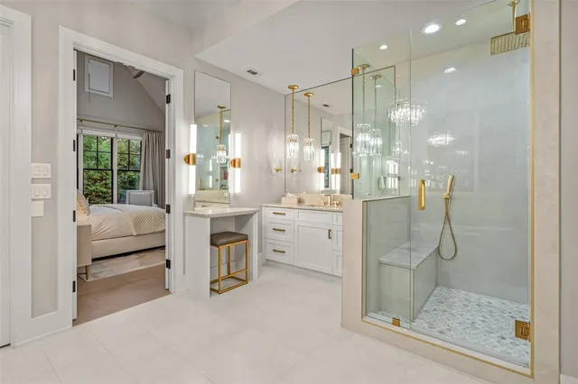 a spacious bathroom with a granite countertop tub sink and mirror