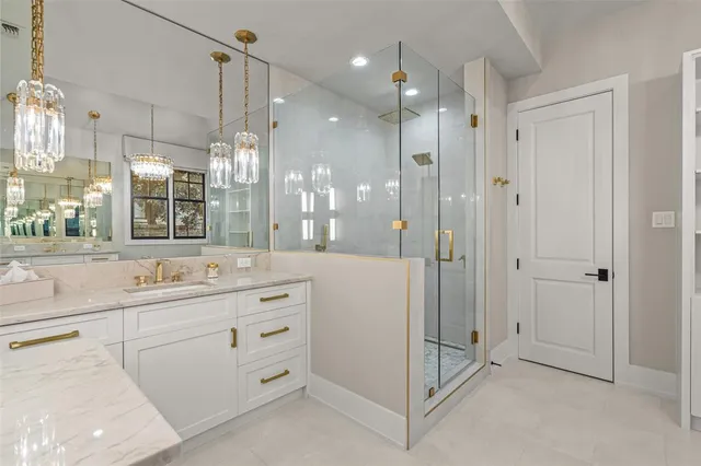 a spacious bathroom with a sink a large mirror and a bathtub