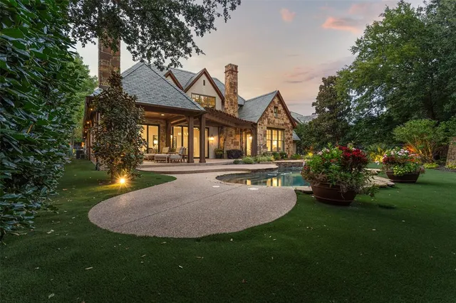 a swimming pool with barbeque oven and outdoor seating
