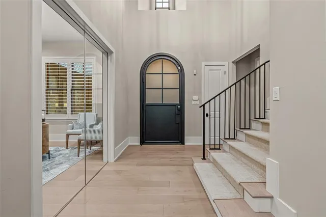 a view of a hallway with staircase and white walls