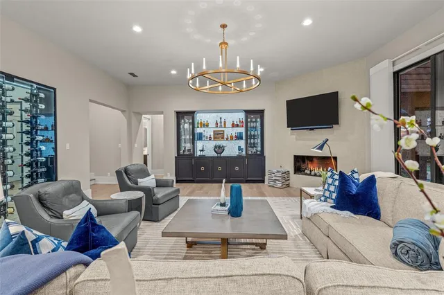 a living room with furniture kitchen and a large window
