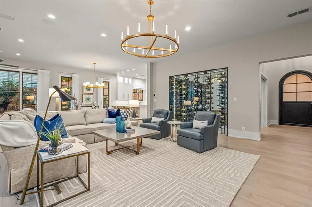 a living room with furniture a flat screen tv and a large window