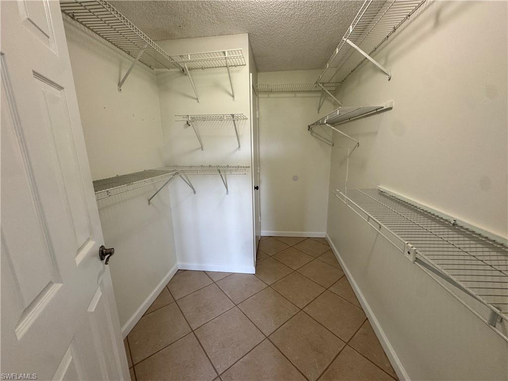 5667 Rattlesnake Hamm Road North, Unit B301 Naples, FL 34113 - Photo 12 of 17 a view of walk in closet