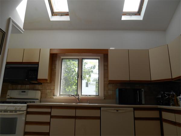 52 Meacham Road, Unit 52 Somerville, MA 02144 - Photo 6 of 12 a kitchen with a window a sink and a cabinets