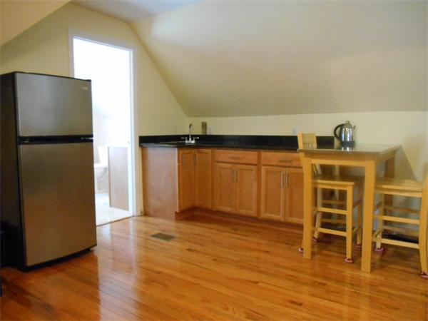 52 Meacham Road, Unit 52 Somerville, MA 02144 - Photo 10 of 12 a view of a livingroom with a kitchen