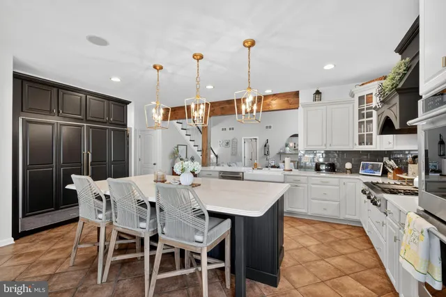 a living room with furniture a flat screen tv and a large window