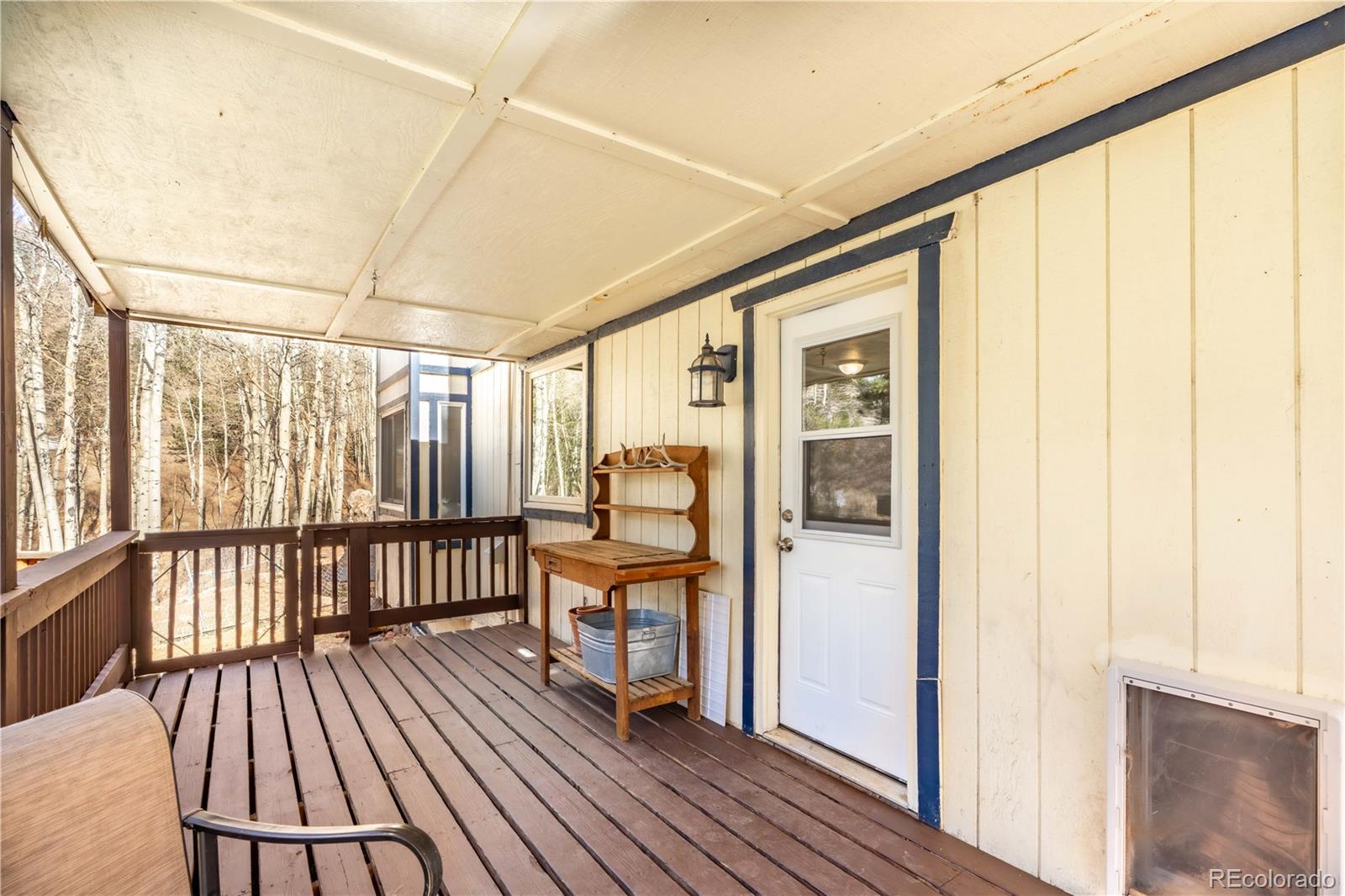 109 Heide Road Shawnee, CO 80475 - Photo 24 of 26 a view of a balcony with furniture and wooden floor