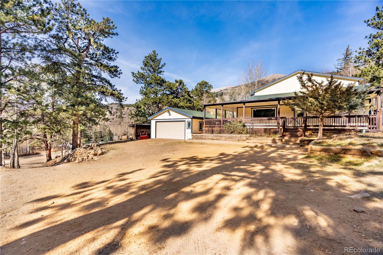 109 Heide Road Shawnee, CO 80475 - Photo 3 of 26 a front view of a house with a yard