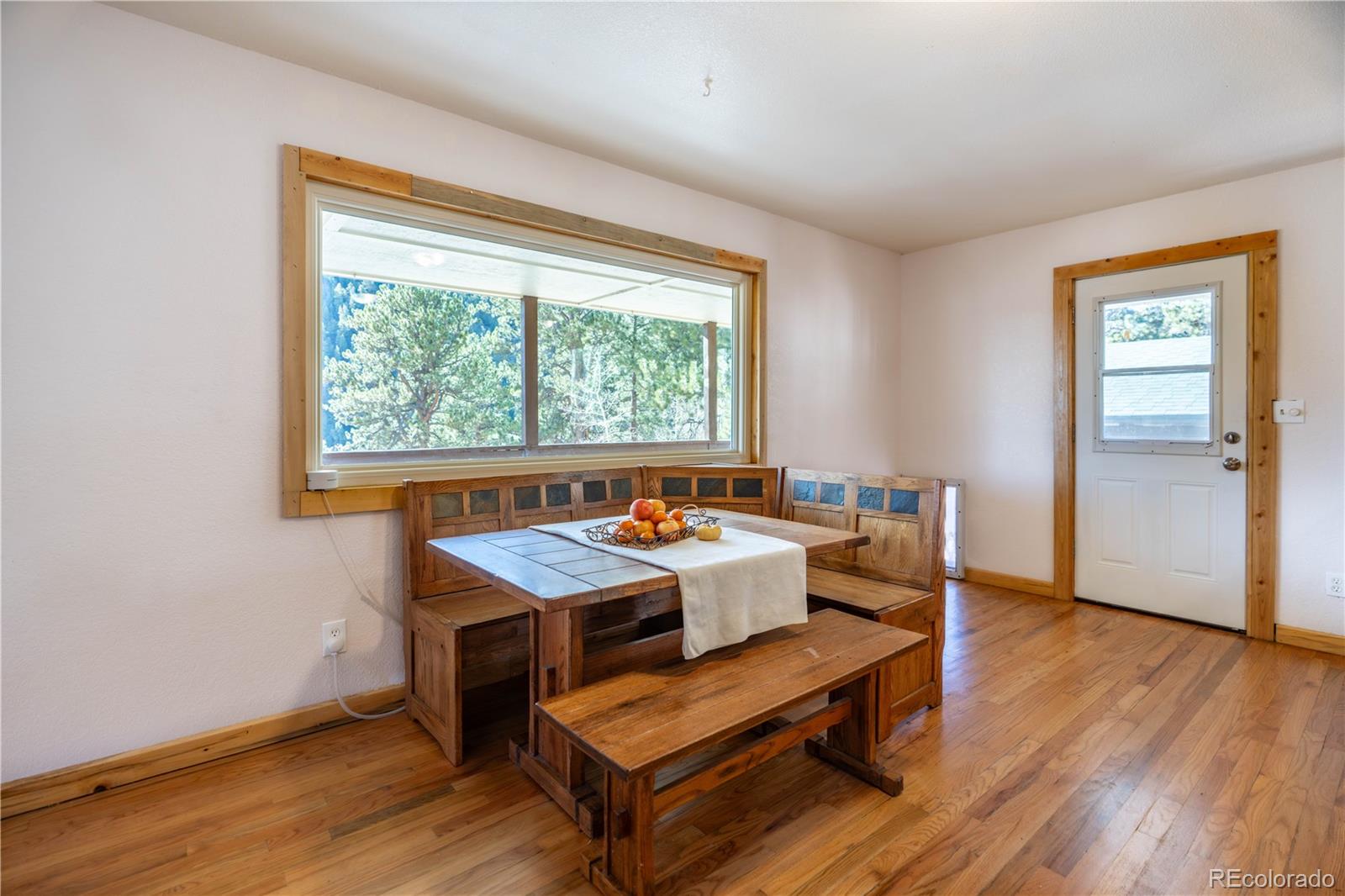 109 Heide Road Shawnee, CO 80475 - Photo 7 of 26 a view of a dining room with furniture window and wooden floor