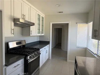 a kitchen with stainless steel appliances granite countertop a stove and a sink