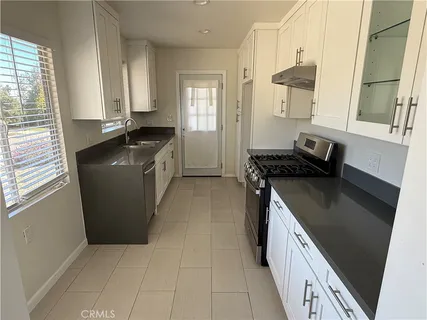 a kitchen with a refrigerator and a sink