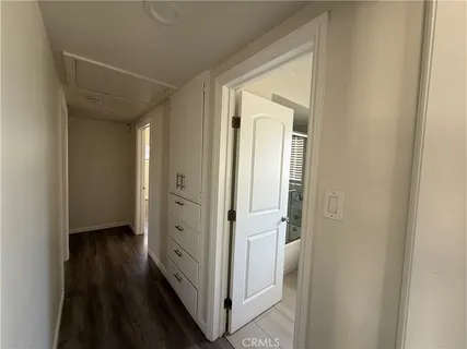 a view of a hallway with wooden floor