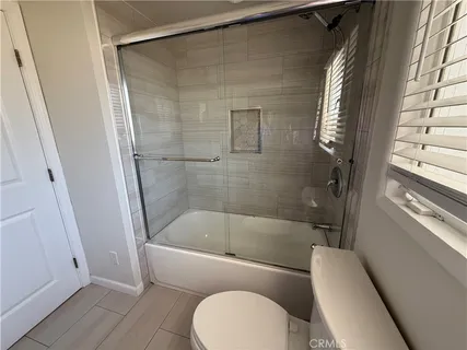 a bathroom with a toilet and a bathtub