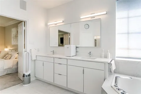 a bathroom with a shower a sink and a mirror