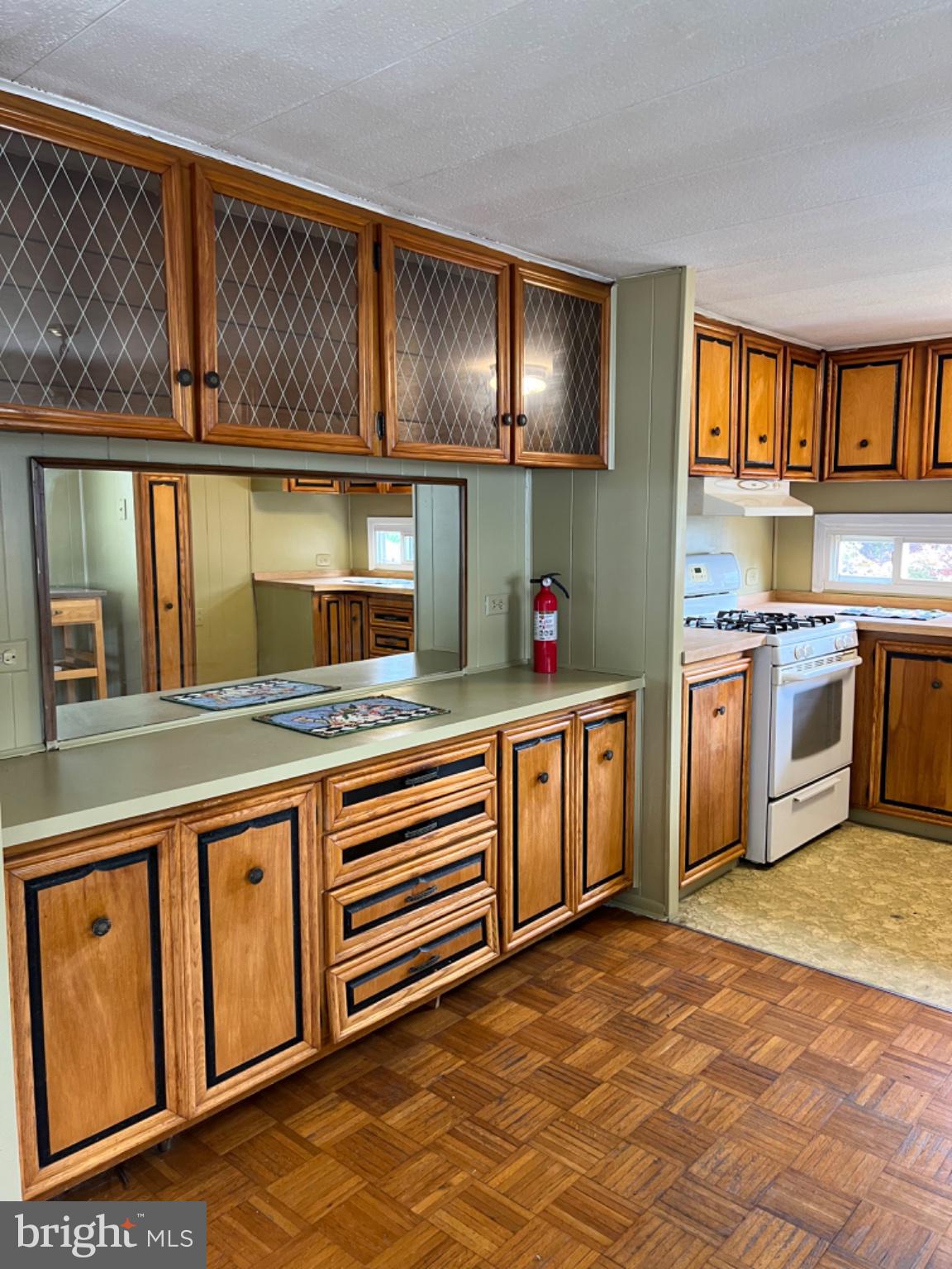 1302 Gibson Road, Unit 152 Bensalem, PA 19020 - Photo 4 of 18 a kitchen with stainless steel appliances granite countertop a stove a sink and a microwave