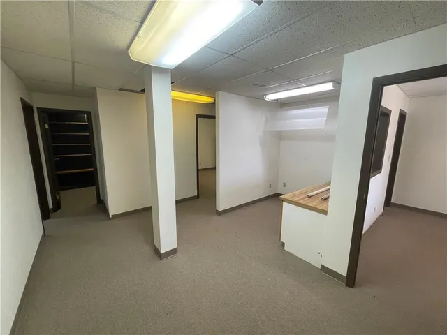 a bathroom with a toilet sink mirror and vanity