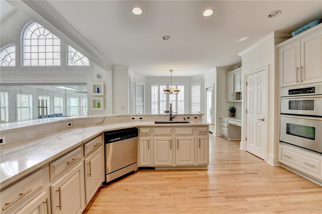 1830 Briergate Drive Duluth, GA 30097 - Photo 12 of 61 a large white kitchen with stainless steel appliances granite countertop a stove and a sink