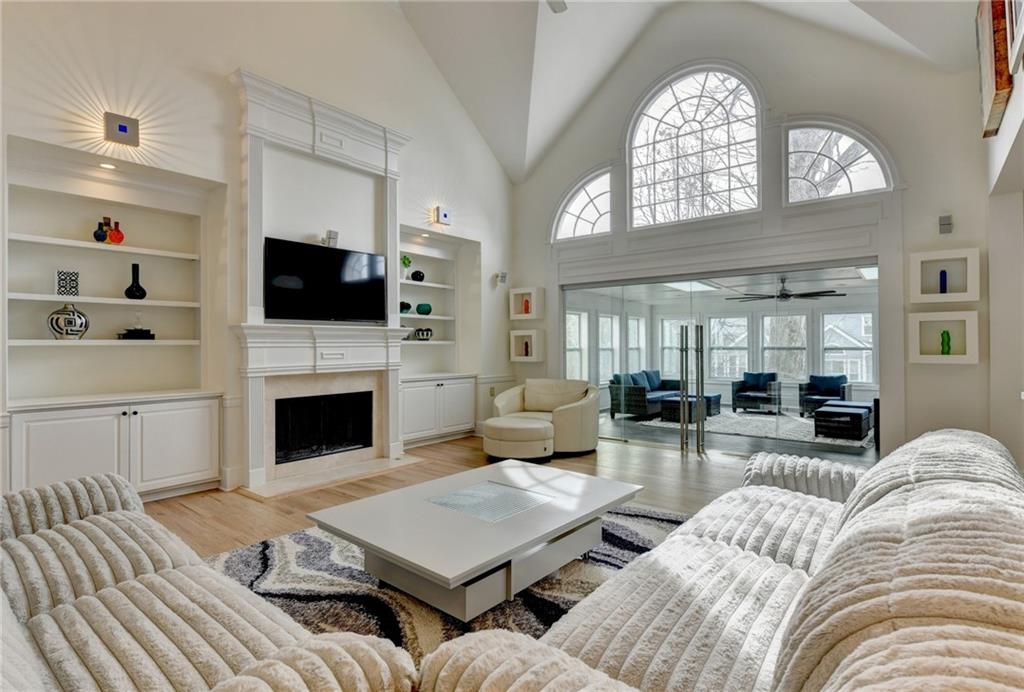 1830 Briergate Drive Duluth, GA 30097 - Photo 17 of 61 a living room with furniture a fireplace and a flat screen tv
