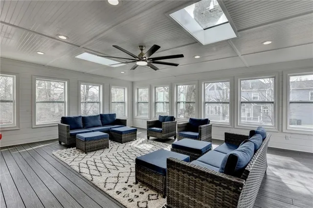a large bathroom with a granite countertop double vanity sink a mirror and a bathtub