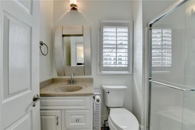a front view of a house with a yard and balcony