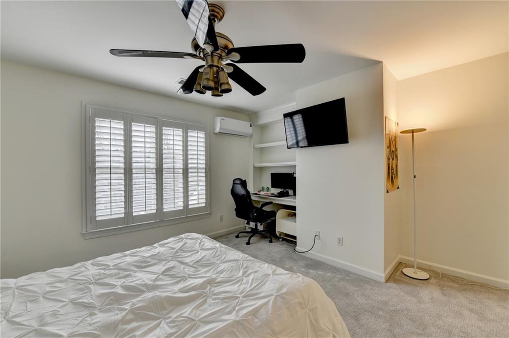 1830 Briergate Drive Duluth, GA 30097 - Photo 35 of 61 a bedroom with a bed and a flat screen tv