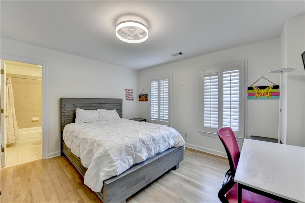 1830 Briergate Drive Duluth, GA 30097 - Photo 37 of 61 a bedroom with a bed and a table in it