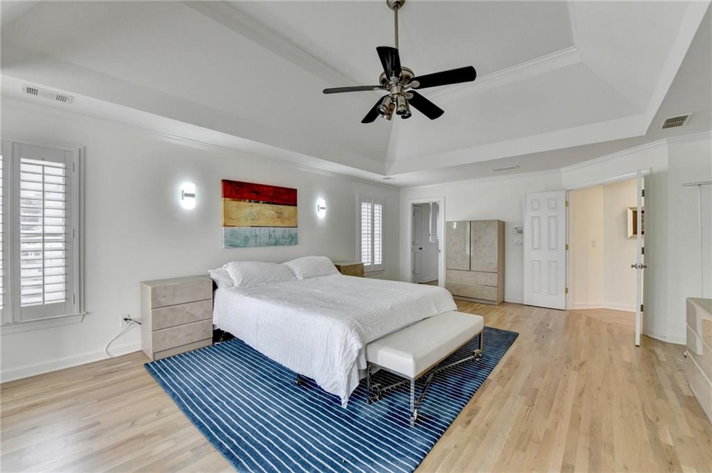 1830 Briergate Drive Duluth, GA 30097 - Photo 42 of 61 a spacious bedroom with a bed and a chandelier