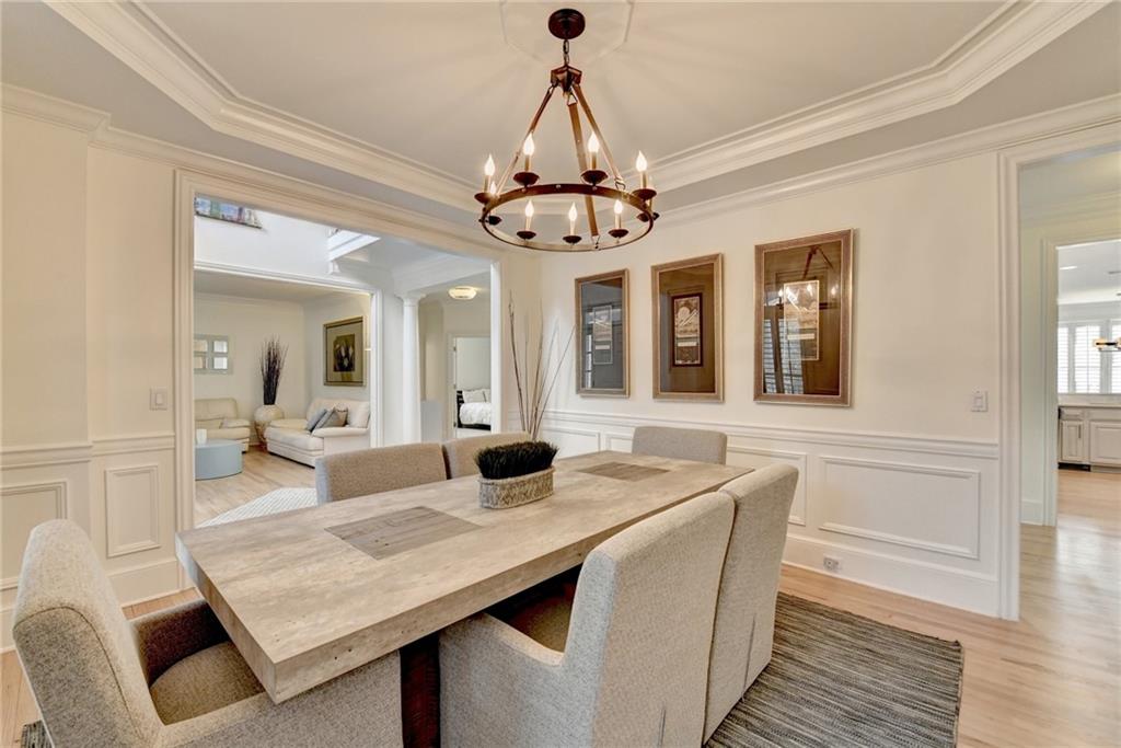 1830 Briergate Drive Duluth, GA 30097 - Photo 7 of 61 a dining room with wooden floor a chandelier a wooden table and chairs