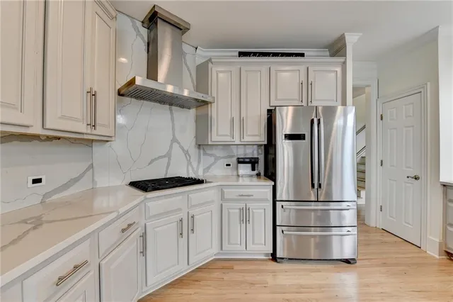 a living room with furniture ceiling fan and a large window