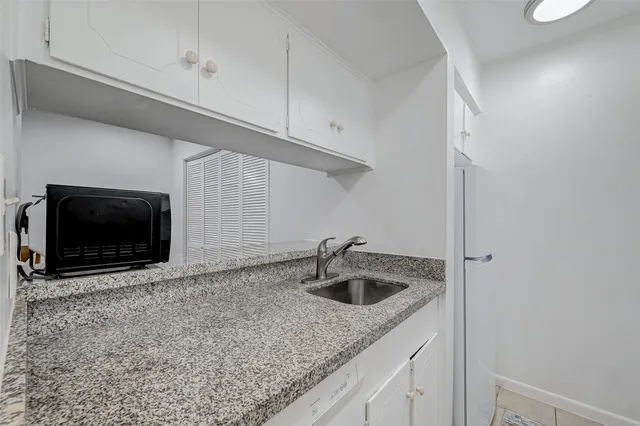 a kitchen with stainless steel appliances granite countertop a sink and a microwave