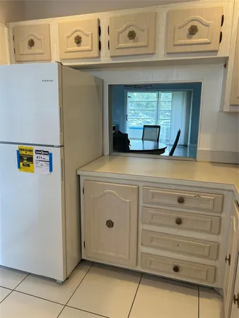 a kitchen with white cabinets appliances and a sink