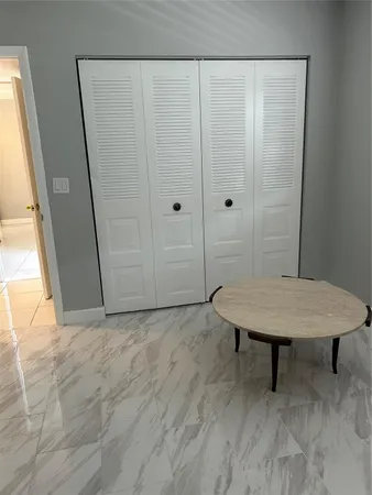 a white toilet sitting next to a bath tub