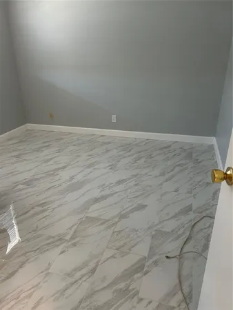 a view of an empty room and wooden floor