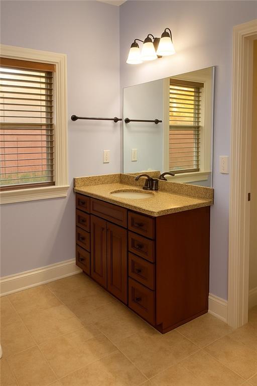 2231 Cain Commons Drive Dacula, GA 30019 - Photo 13 of 20 a bathroom with a granite countertop sink and a window