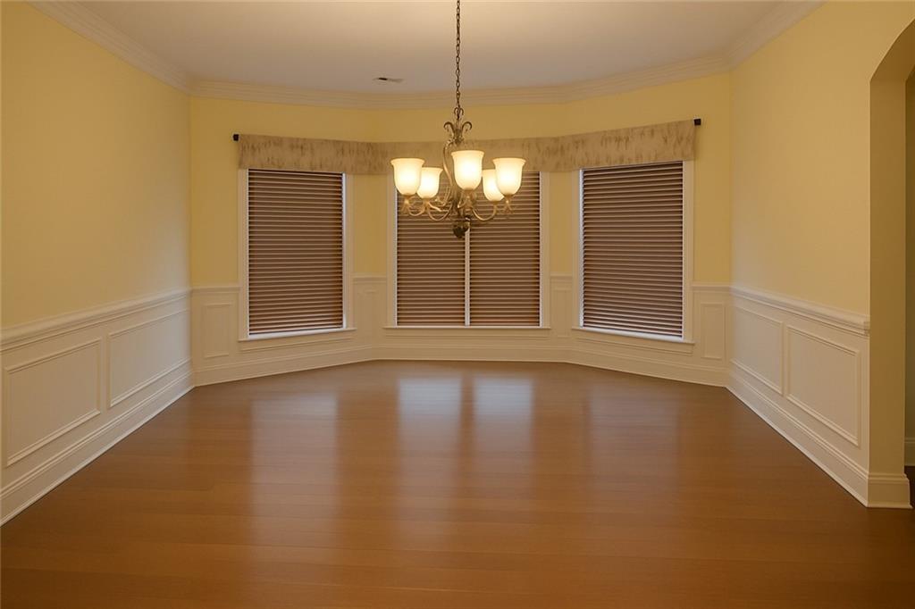 2231 Cain Commons Drive Dacula, GA 30019 - Photo 6 of 20 a view of an empty room with window and chandelier fan