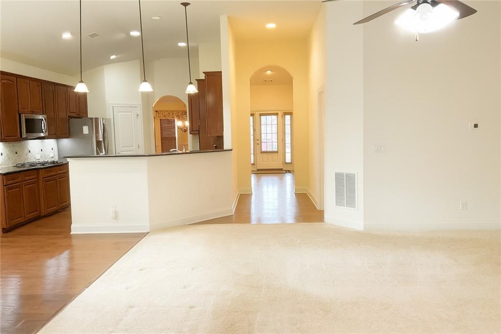 2231 Cain Commons Drive Dacula, GA 30019 - Photo 8 of 20 a view of a kitchen with a sink and a refrigerator