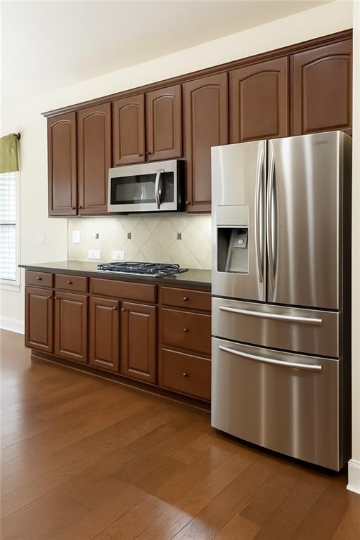 2231 Cain Commons Drive Dacula, GA 30019 - Photo 10 of 20 a kitchen with stainless steel appliances granite countertop a refrigerator and a stove top oven