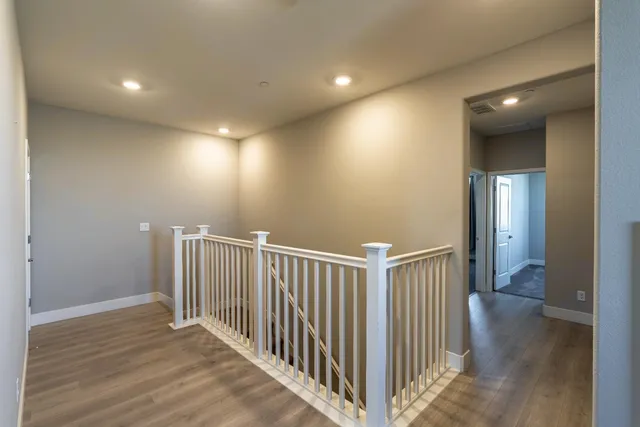 a view of hallway with wooden floor