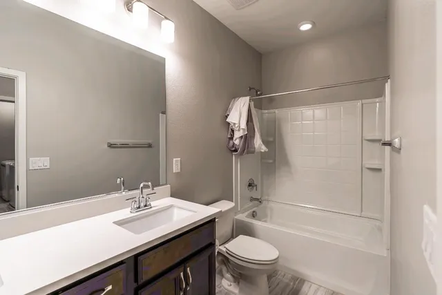 a bathroom with a sink toilet and shower