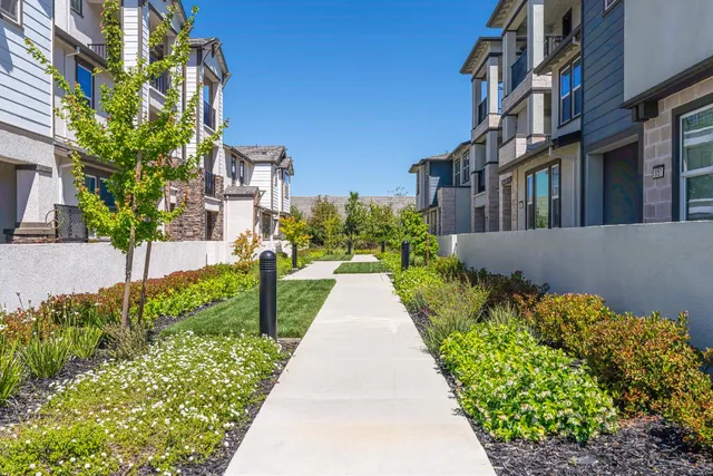 a view of a pathway with a house in the background