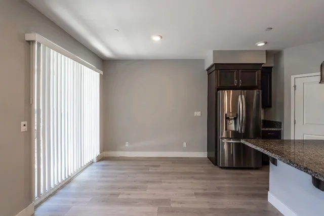 a view of a refrigerator in kitchen and wooden floor