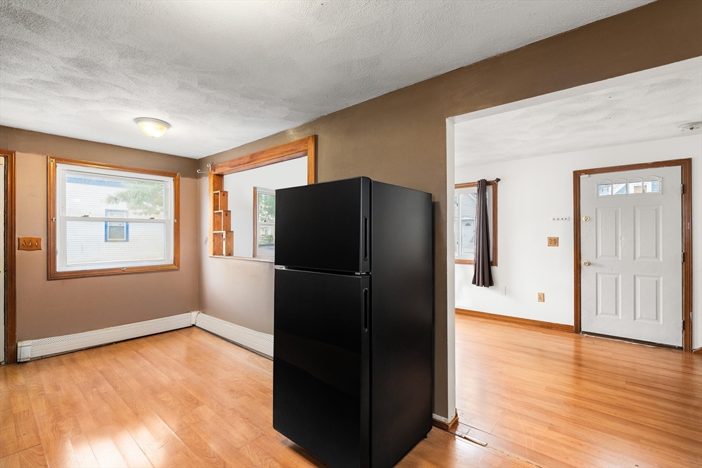 23 Logan Street Lynn, MA 01902 - Photo 9 of 27 a view of empty room with wooden floor and window