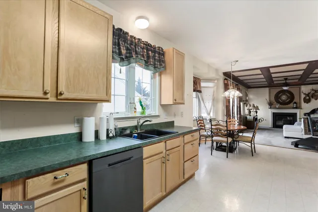 a kitchen with stainless steel appliances a sink a stove and cabinets